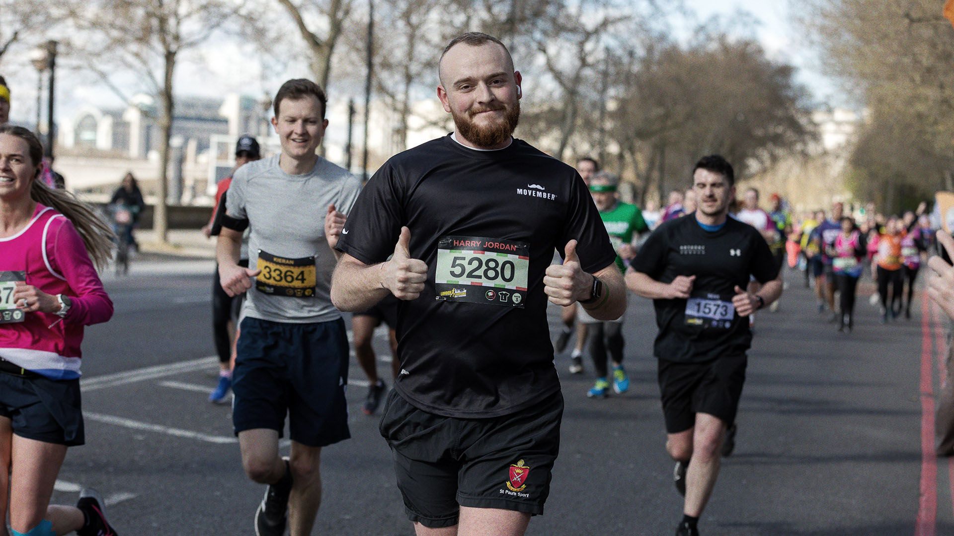 Athletic marathon runner, giving thumbs up to camera.