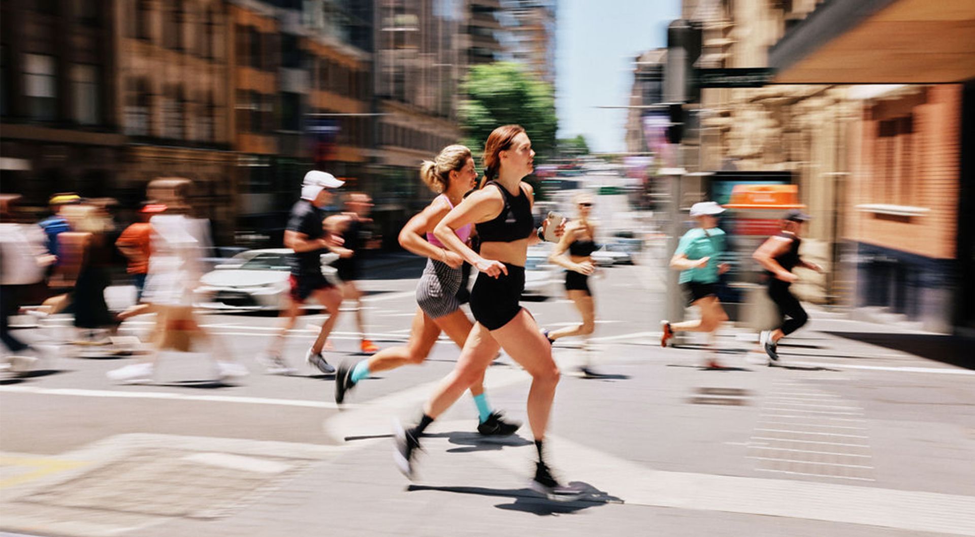 Black and white photo of running group, joyously approaching camera.